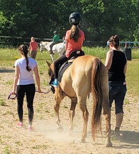 rider on horse led by volunteers